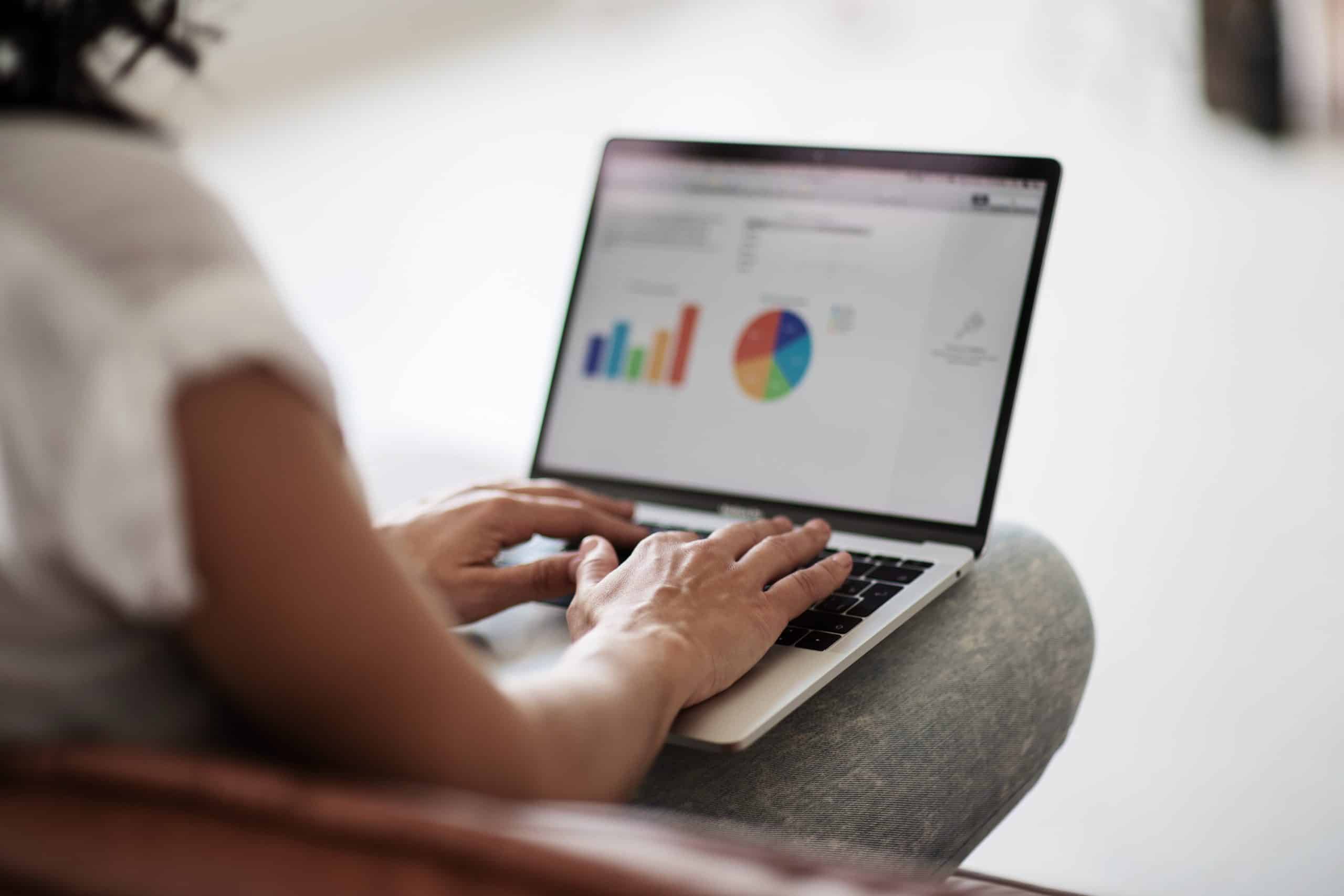 team member sitting reviewing ecommerce dashboard on a laptop